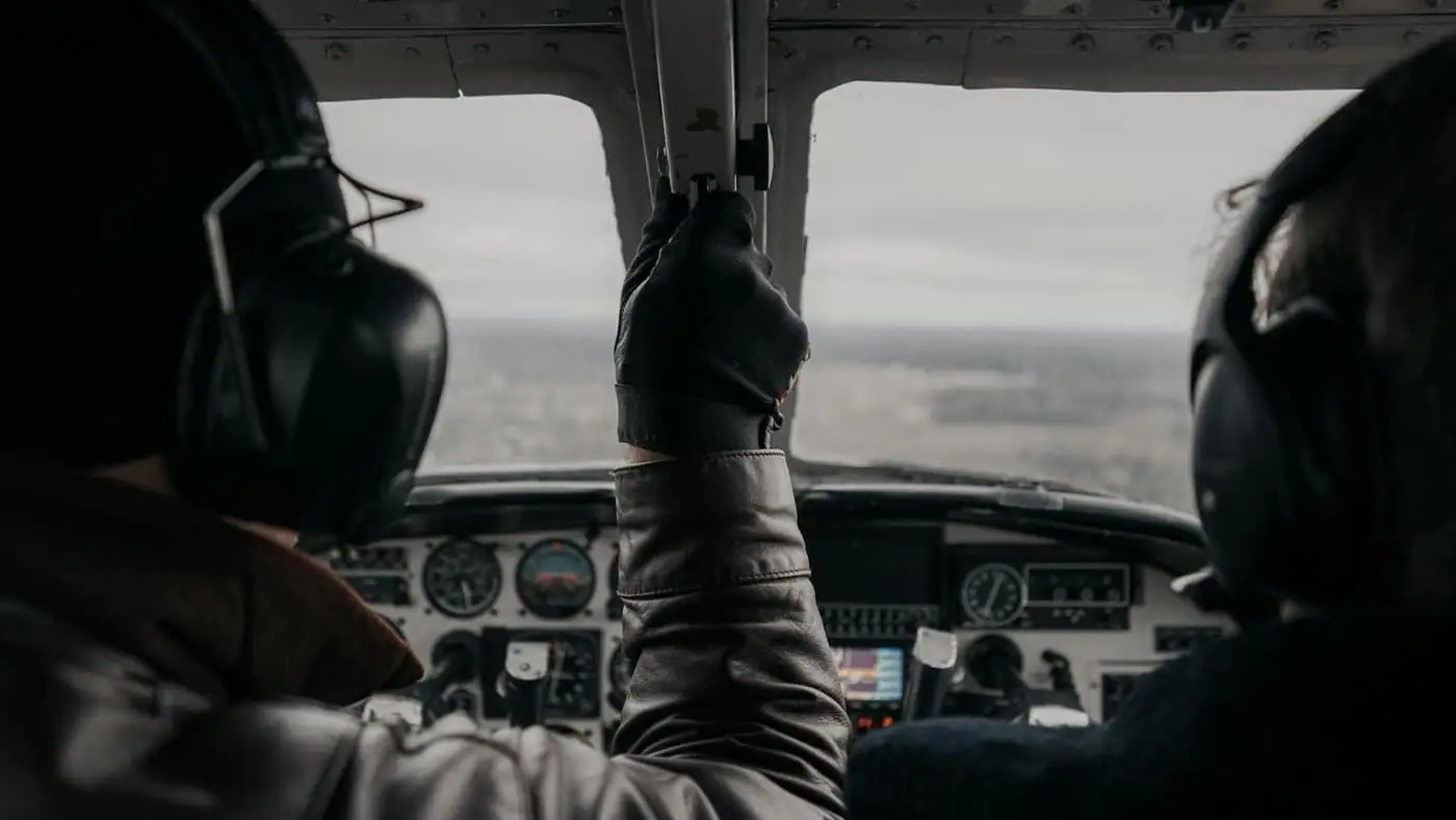 Two pilots in a small aircraft cockpit